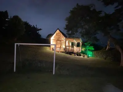 a house on a hill at night with a goal at Hermoso chalet en marinilla in Marinilla
