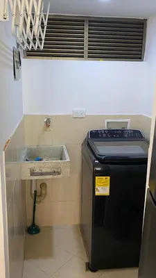 a small kitchen with a sink and a stove at Pie de Cerro Condominium in Medellín