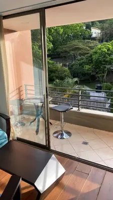 a view of a balcony with a table and a chair at Pie de Cerro Condominium in Medellín