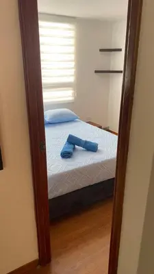 a mirror reflecting a bed in a bedroom at Pie de Cerro Condominium in Medellín