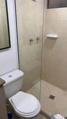 a bathroom with a toilet and a shower at Pie de Cerro Condominium in Medellín