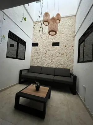 a living room with a couch and a table at Apartahotel-sevilla in Medellín