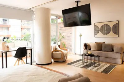 a living room with a couch and a tv at New Apt w private Jacuzzi & AC in Medellín
