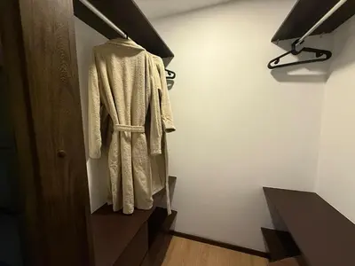 a robe hanging on a door in a room at New Apt w private Jacuzzi & AC in Medellín