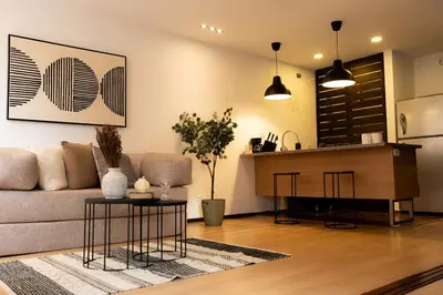 a living room with a couch and a table at New Apt w private Jacuzzi & AC in Medellín