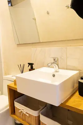 a bathroom with a white sink and a mirror at New Apt w private Jacuzzi & AC in Medellín
