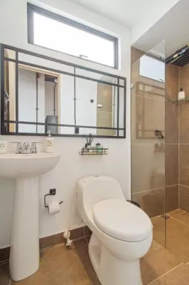 a bathroom with a toilet and a sink and a shower at Studio30 A, Belen, Los Molinos in Medellín