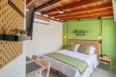 a bedroom with a bed and a green wall at Studio30 A, Belen, Los Molinos in Medellín