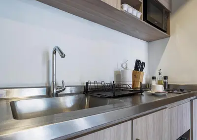 a stainless steel kitchen counter with a sink at Stylish Loft in the Heart of Laureles in Medellín