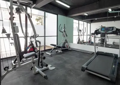 a gym with three exercise bikes and a treadmill at Stylish Loft in the Heart of Laureles in Medellín