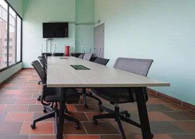 a conference room with a long table and chairs at Stylish Loft in the Heart of Laureles in Medellín