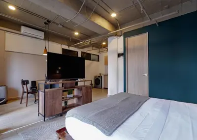 a bedroom with a bed and a flat screen tv at Stylish Loft in the Heart of Laureles in Medellín