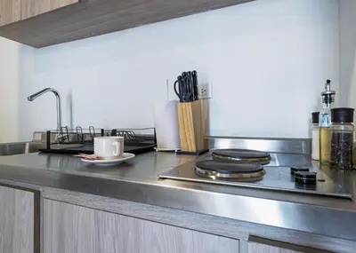a kitchen with a stainless steel counter top with a stove at Stylish Loft in the Heart of Laureles in Medellín