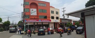 a group of people standing in front of a building at Hotel La Rosa in Mariquita