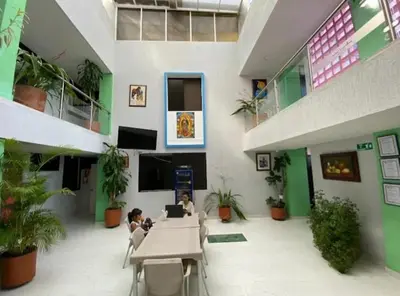 two children sitting at a table in a building at Hotel La Rosa in Mariquita