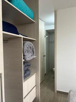 a room with a closet with towels on shelves at CENTRO historico y CC FUNDADORES in Manizales