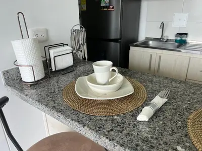 a kitchen counter with a plate with a coffee cup on it at CENTRO historico y CC FUNDADORES in Manizales