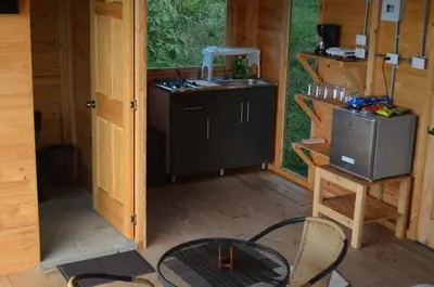 an outside view of a kitchen in a cabin at Refugio Tororoi in Copacabana