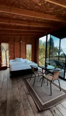 a bedroom with a bed and a table and chairs at Refugio Tororoi in Copacabana
