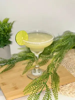 a margarita in a martini glass with a lime at Novus Laureles in Medellín