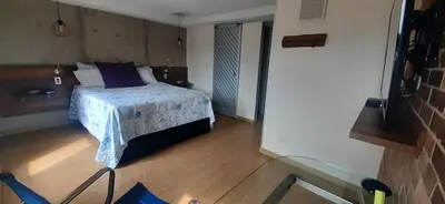a bedroom with a bed with a blue comforter at Luxury Laureles-LA 70-Medellin Stunner in Medellín