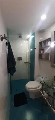 a bathroom with a toilet and a glass shower at Luxury Laureles-LA 70-Medellin Stunner in Medellín
