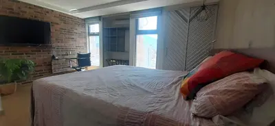 a bedroom with a bed and a brick wall at Modern, Stylish, Awesome Locacion, Gorgeous Views in Medellín