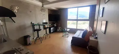 a living room with a couch and a window at Modern, Stylish, Awesome Locacion, Gorgeous Views in Medellín