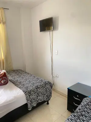 a hotel room with a bed and a lamp in it at Hotel La Aldea in Guatapé