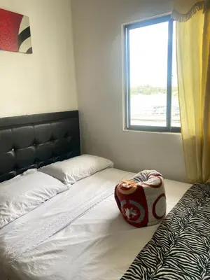 a bedroom with two beds and a window at Hotel La Aldea in Guatapé