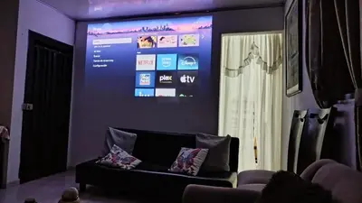 a living room with a couch and a large screen at DESTINY Apto Central in San Rafael