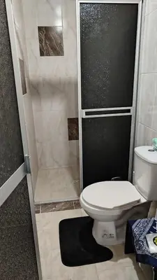a small bathroom with a toilet and a shower at DESTINY Apto Central in San Rafael
