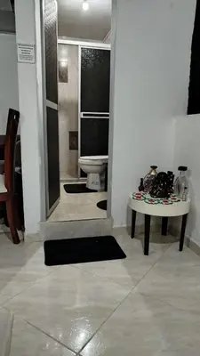 a room with a bathroom with a table and a toilet at DESTINY Apto Central in San Rafael