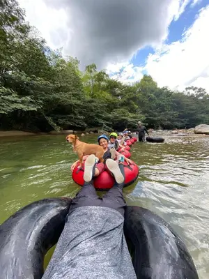 a group of people and a dog on a raft in the water at DESTINY Apto Central in San Rafael