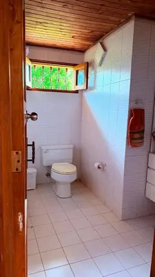 a small bathroom with a toilet and a window at Finca 5 Continentes - Cerca MatroCable ARVI in Guarne