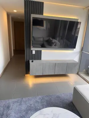 a living room with a large tv on a wall at Lujoso apartamento, 3 habitaciones, mejor ubicación in Medellín