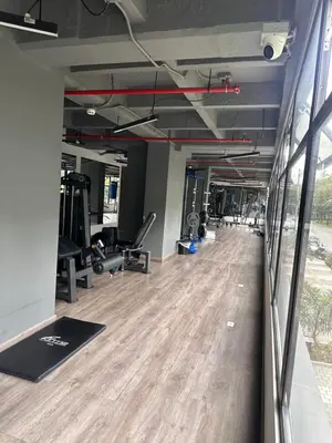 a gym with treadmills and ellipticals and a wooden floor at Lujoso apartamento, 3 habitaciones, mejor ubicación in Medellín
