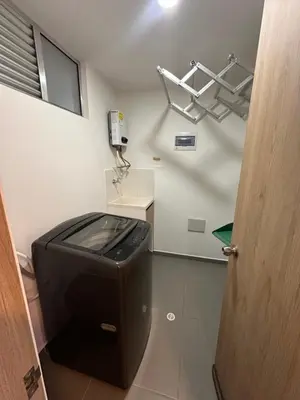a bathroom with a toilet with a phone on the wall at Lujoso apartamento, 3 habitaciones, mejor ubicación in Medellín