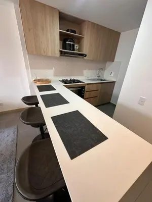a kitchen with a white counter with black crosses on it at Apartamento en Medellín poblado in Medellín