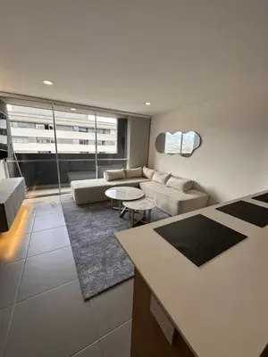 a living room with a couch and a table at Apartamento en Medellín poblado in Medellín