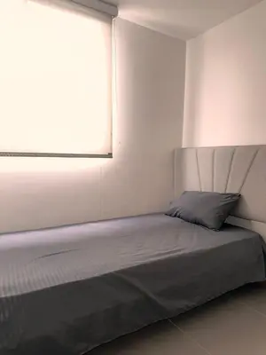 a bed in a room with a window at Apartamento en Medellín poblado in Medellín