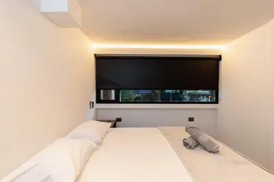 a bedroom with a bed with a large window at Ll 203 4BR 4Bath Apartment close to lleras park - Poblado - Medellín in Medellín