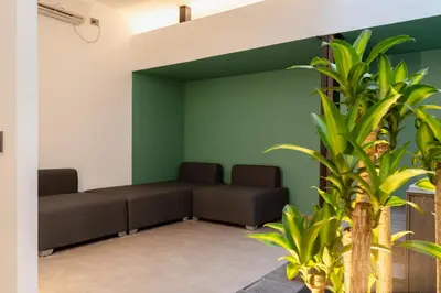 a waiting room with two benches and a green wall at Ll 203 4BR 4Bath Apartment close to lleras park - Poblado - Medellín in Medellín