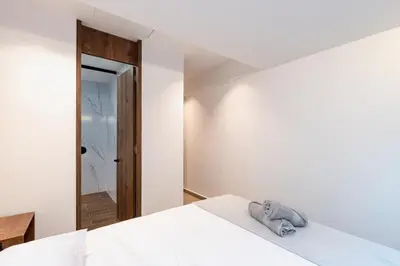 a bedroom with a bed with a stuffed animal on it at Ll 203 4BR 4Bath Apartment close to lleras park - Poblado - Medellín in Medellín