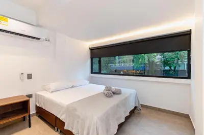 a bedroom with a bed and a large window at Ll 203 4BR 4Bath Apartment close to lleras park - Poblado - Medellín in Medellín