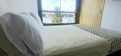 a bed in a room with a large window at Cold AC-fast Wi-Fi-great location-Medellin fun in Medellín