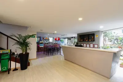 a restaurant with a counter and a bar in a room at Cold AC-fast Wi-Fi-great location-Medellin fun in Medellín