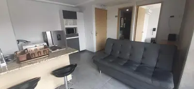 a living room with a black couch in a room at Cold AC-fast Wi-Fi-great location-Medellin fun in Medellín