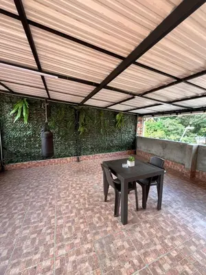a patio with a table and chairs under a wooden ceiling at Apartamento en Itagüí in Itagüí