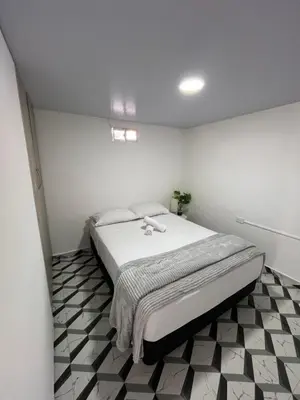 a bedroom with a bed in a white room at Apartamento en Itagüí in Itagüí